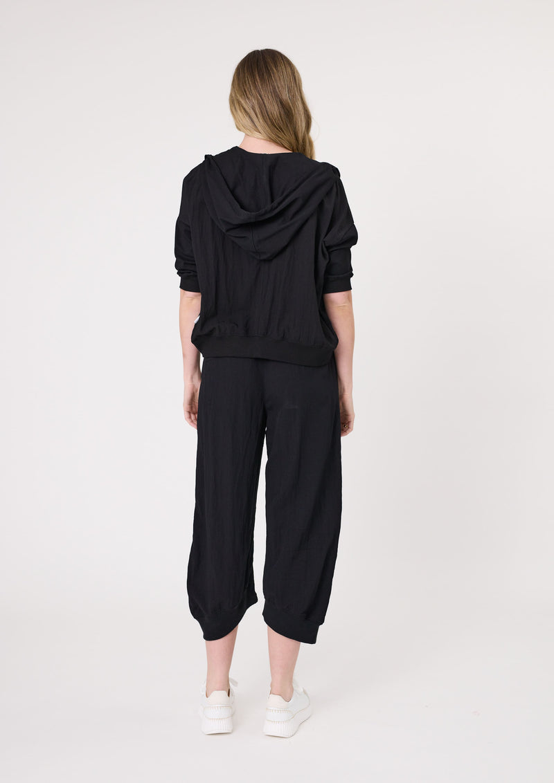 Person wearing a black hoodie and black pants on a white background
Larissa Pant Black