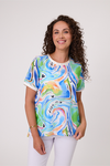 Woman wearing a colorful t-shirt with abstract designs on a white background Life Top Green