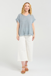 Woman wearing a light blue top and white pants on a white background
Lilah Top Grey