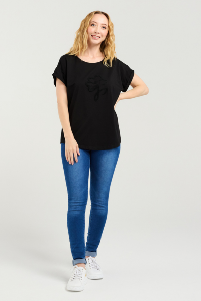 Woman wearing a black t-shirt and blue jeans on a white background Lily Top Black