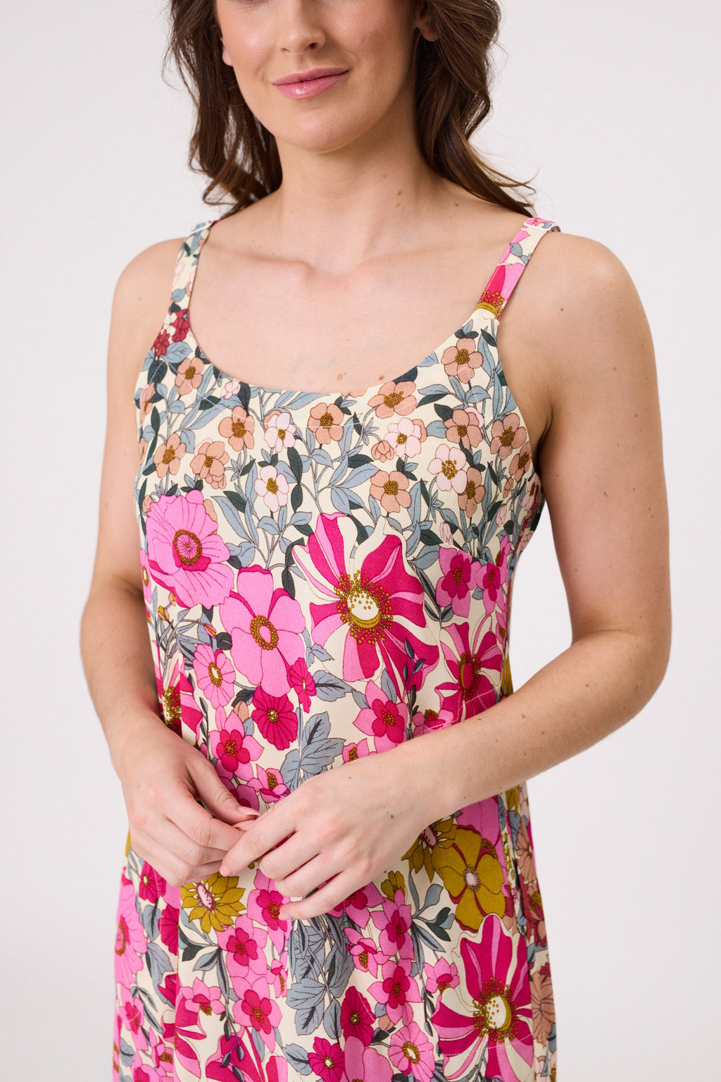 Woman wearing a floral dress with pink and multicolor flowers on a plain background
Maddie Dress Garden Print