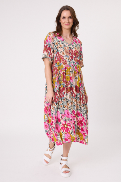 Woman wearing a colorful floral dress on a white background
Marissa Dress Garden Print