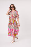 Woman wearing a colorful floral dress on a white background
Marissa Dress Garden Print