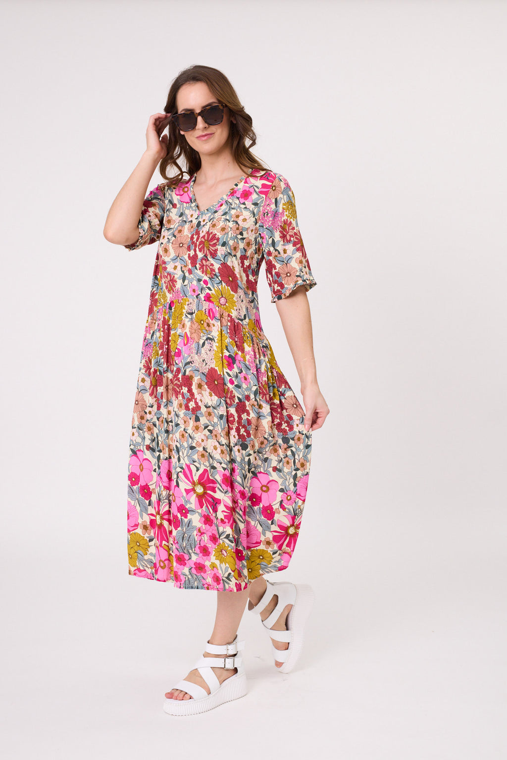 Woman wearing a colorful floral dress on a white background
Marissa Dress Garden Print