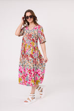 Woman wearing a colorful floral dress on a white background
Marissa Dress Garden Print