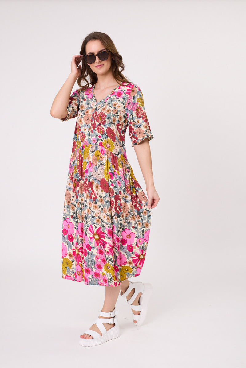 Woman wearing a colorful floral dress on a white background
Marissa Dress Garden Print