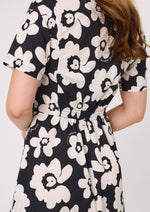 Black dress with white floral pattern worn by a person on a plain background Marta Floral Dress Black/White