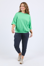 Woman wearing a green top and navy pants on a white background
Mazie Sweat Spring Green