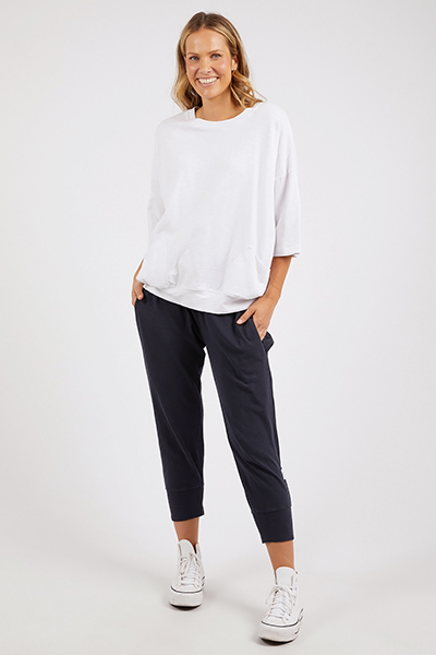 Woman wearing a white top and navy pants on a white background
Mazie Sweat White