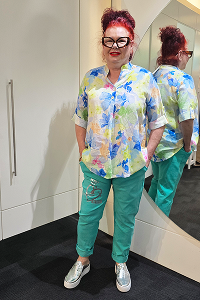 Person wearing a colorful shirt and teal pants standing in front of a mirror.
Metallic Heart Magic Pants Turquoise