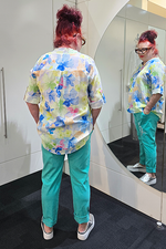 Person wearing a colorful shirt and teal pants standing in front of a mirror.
Metallic Heart Magic Pants Turquoise