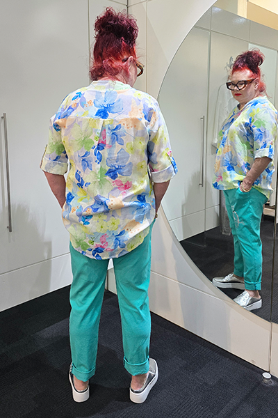 Person wearing a colorful shirt and teal pants standing in front of a mirror.
Metallic Heart Magic Pants Turquoise