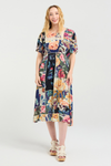 Woman wearing a colorful floral dress on a white background
Myla Dress Flower Party