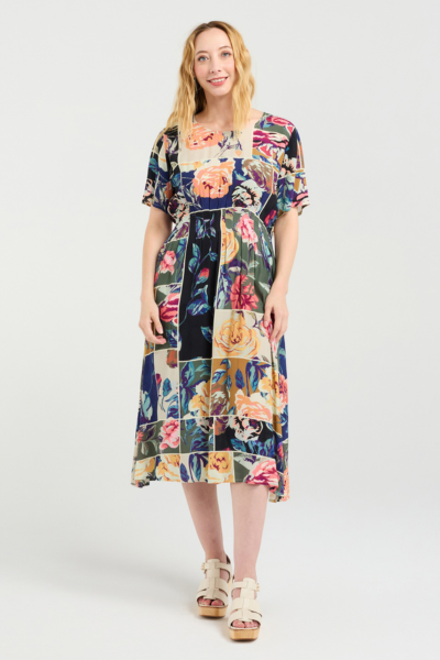 Woman wearing a colorful floral dress on a white background
Myla Dress Flower Party