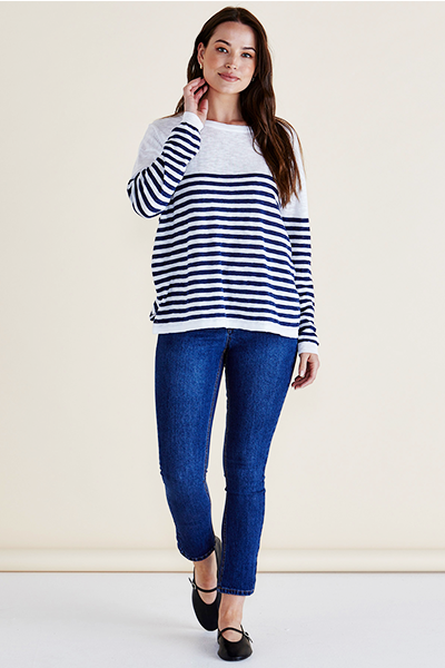 Woman wearing a navy and white striped sweater with blue jeans on a plain background
Natasha Knit Top White/Navy