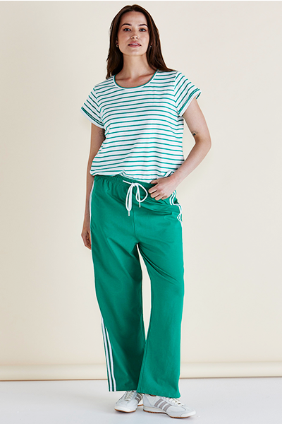 Woman wearing a striped shirt and green pants with white stripes on a plain background
Nikki Relax Cotton Jogger Green