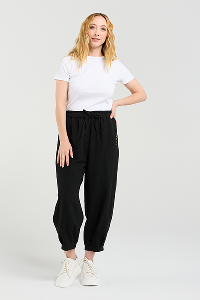 Woman wearing a white t-shirt and black pants on a white background Nova Pants Black