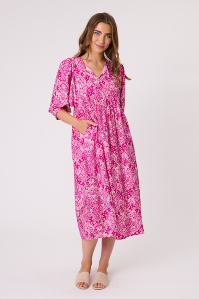 Woman wearing a pink floral dress on a white background Paisley Dress Hot Pink