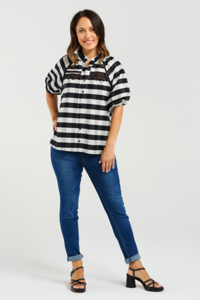 Woman wearing a black and white striped shirt and blue jeans on a white background
Penelope Blouse Black Check