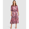 Woman wearing a pink floral dress on a white background