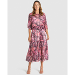 Woman wearing a pink floral dress on a white background