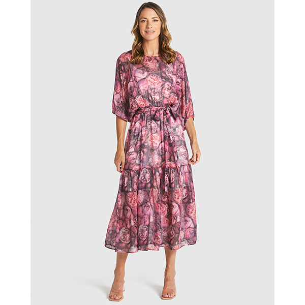 Woman wearing a pink floral dress on a white background