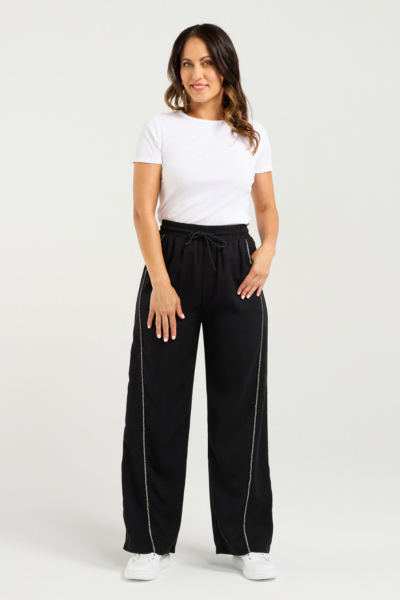 Woman wearing a white t-shirt and black pants on a white background
Polly Pants Black