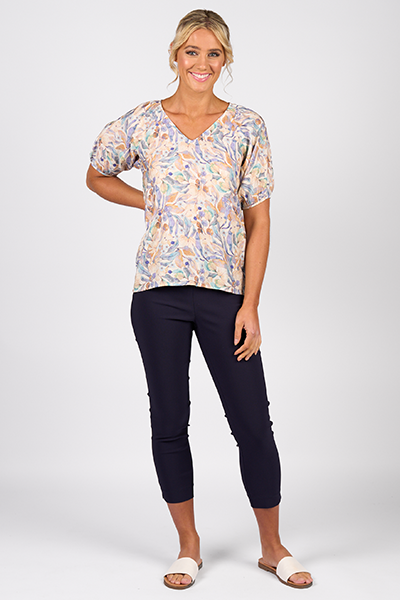Woman wearing a floral blouse and black pants on a white background
Printed V Neck Top Amalfi