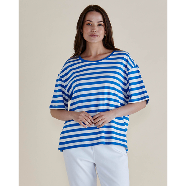 Woman wearing a blue and white striped shirt against a plain background
