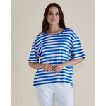 Woman wearing a blue and white striped shirt against a plain background
