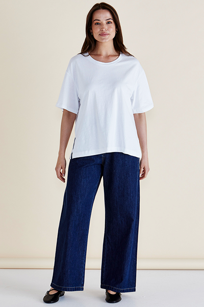 Woman wearing a white t-shirt and blue jeans against a beige background
Relax Boxy Tee White