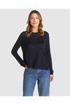 Woman wearing a navy sweater and blue jeans on a white background
Reminiscent Knit Navy