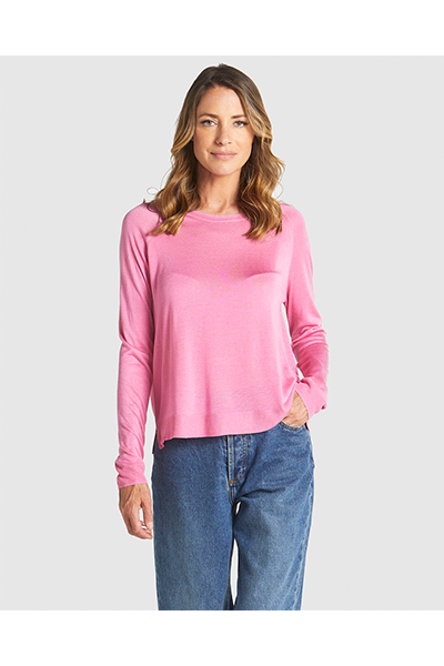 Woman wearing a pink long-sleeve top and blue jeans on a white background
Reminiscent Knit Pink