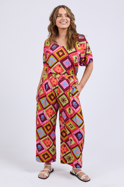 Woman wearing a colorful patterned jumpsuit on a white background
Rhode Pants Geo Print