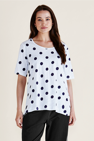 Woman wearing a white t-shirt with black polka dots on a plain background
Riley Polkadot Tee White