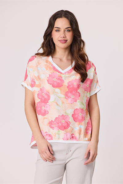 Woman wearing a floral blouse with a plain background Riley Print Top Coral