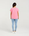 Person wearing a pink t-shirt and light blue jeans on a white background Lily Top Pink