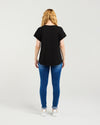 Person wearing a black t-shirt and blue jeans on a white background Lily Top Black