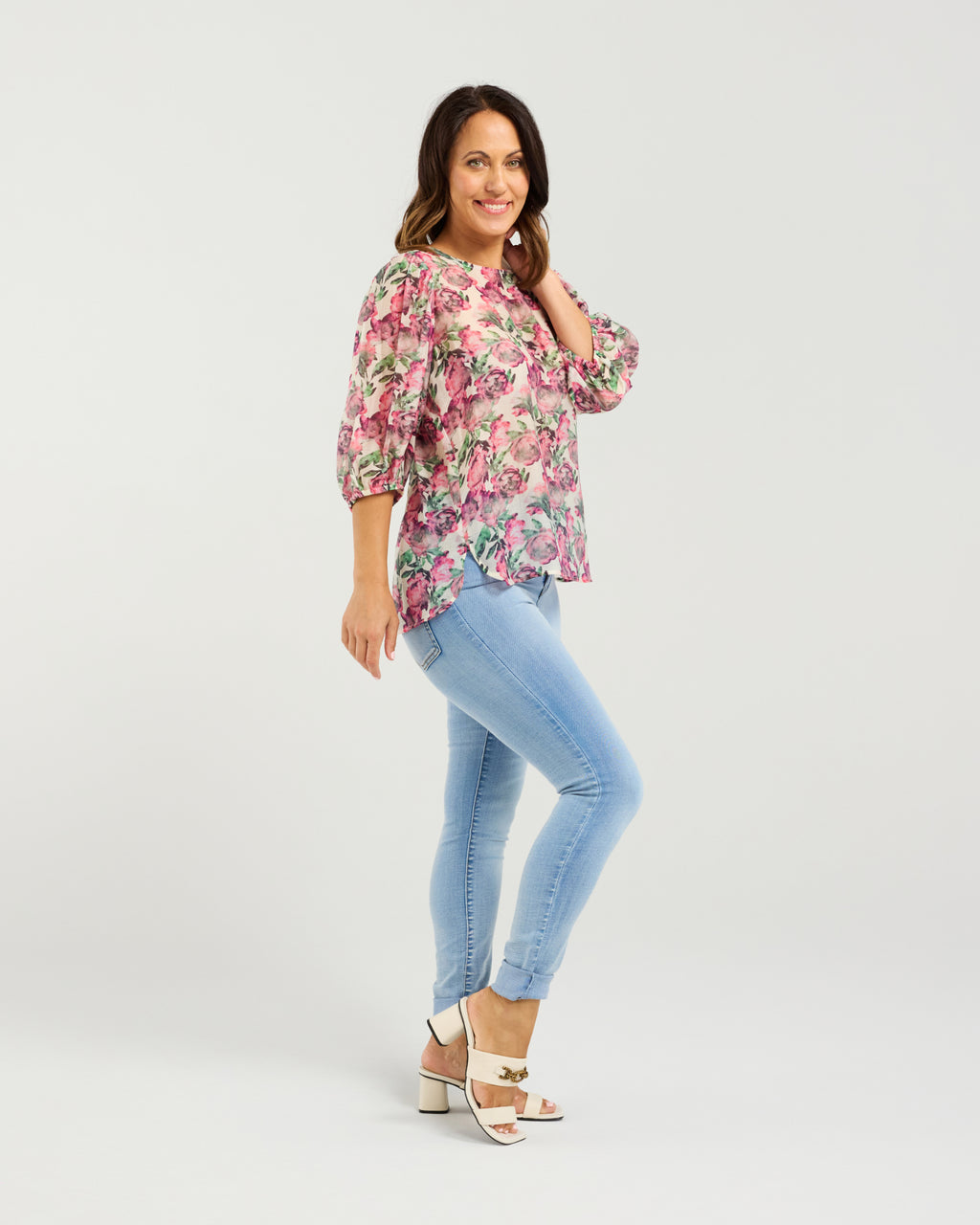 Woman wearing a floral blouse and light blue jeans on a white background
Ariel Top Rose Garden
