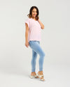 Woman wearing a pink top and light blue jeans on a white background
Lilah Top Pink