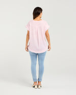 Person wearing a light pink t-shirt and light blue jeans on a white background
Lilah Top Pink