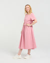 Woman wearing a pink dress on a white background Brodie Dress Pink