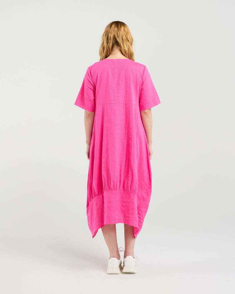 Person wearing a bright pink dress on a white background Selena Dress Hot Pink