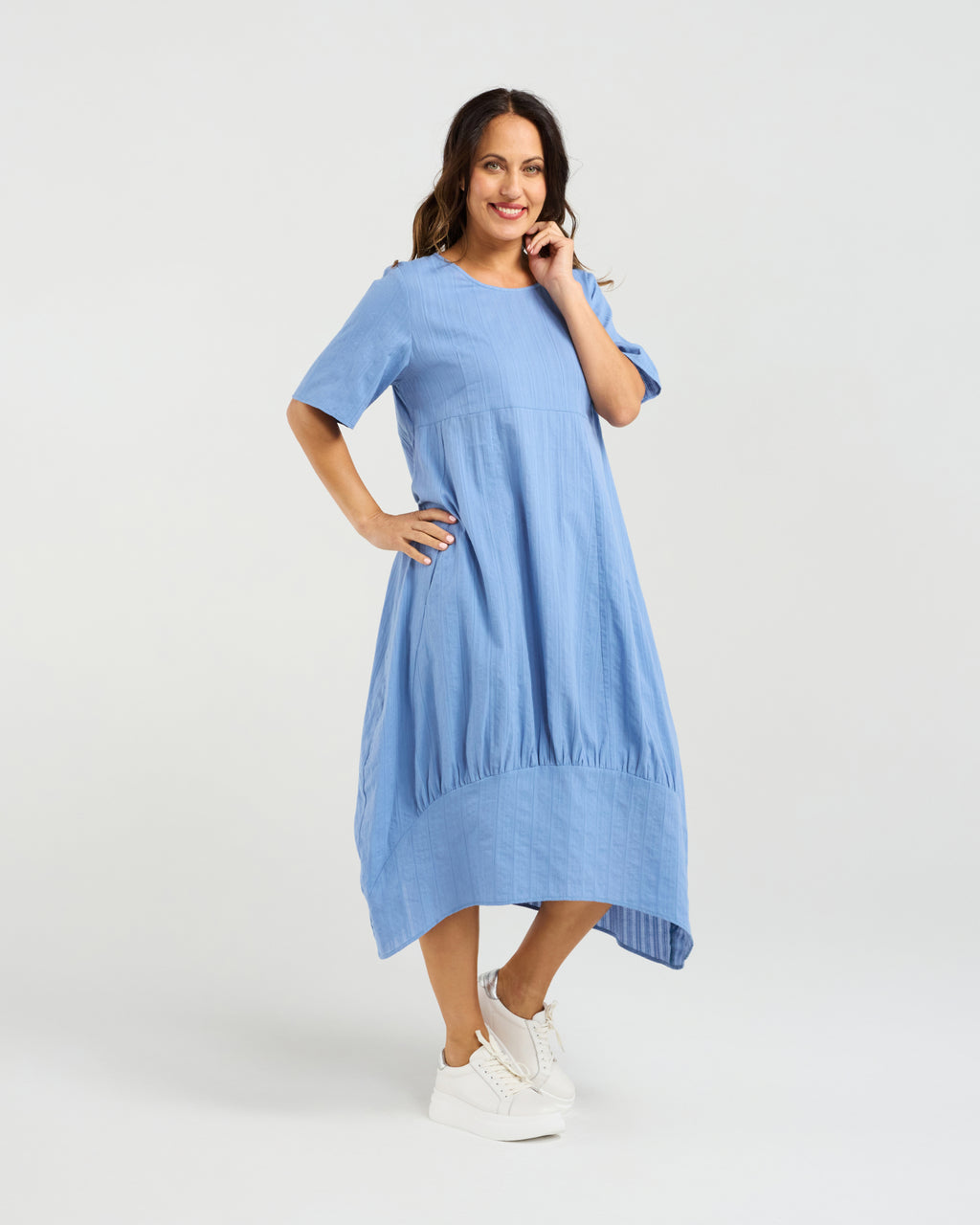 Woman wearing a blue dress on a white background Selena Dress Blue