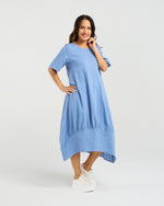 Woman wearing a blue dress on a white background Selena Dress Blue