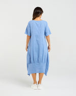 Woman wearing a blue dress on a white background Selena Dress Blue