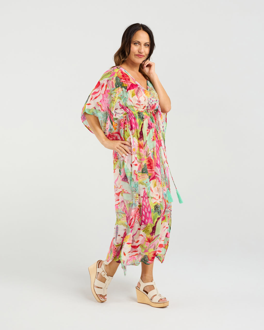 Woman wearing a colorful floral dress on a white background Sonya Dress Blossom Pop