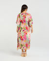 Woman wearing a colorful floral dress on a white background Sonya Dress Blossom Pop