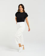 Woman wearing a black top and white pants on a white background
Rhea Pants White