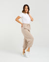 Woman wearing a white t-shirt and beige pants on a white background Nova Pants Natural
